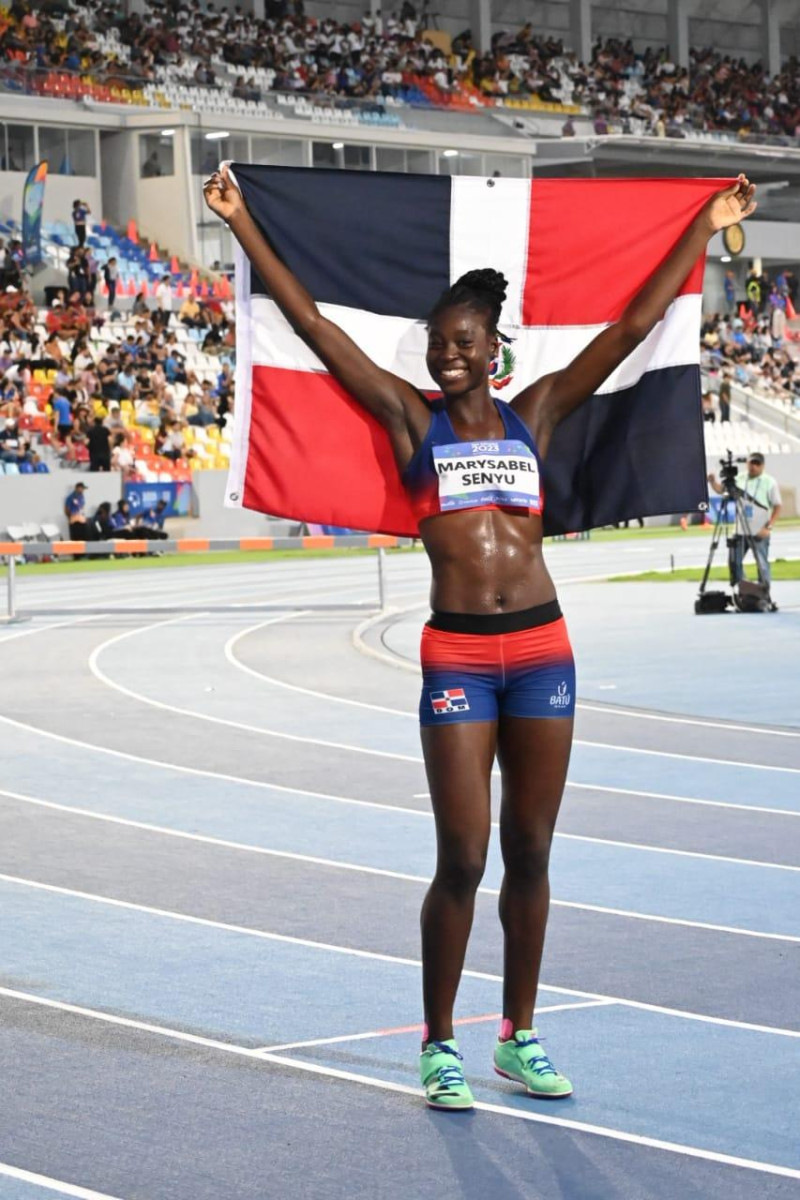 Marysabel Senyú posando con la bandera tricolor, luego de obtener la quinta medalla dorada para el atletismo.