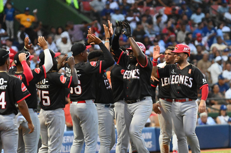 Sanber Pimentel es saludado por sus compañeros del Escogido tras dar su primer jonrón del juego, un tablazo por encima del muro de los 411 pies, en el juego contra el Licey.