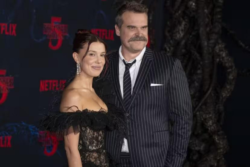 British actress and producer MILLIE BOBBY BROWN and American actor DAVID HARBOUR and attend the Los Angeles red carpet premiere of Netflix's ''Stranger Things'' Season 5.