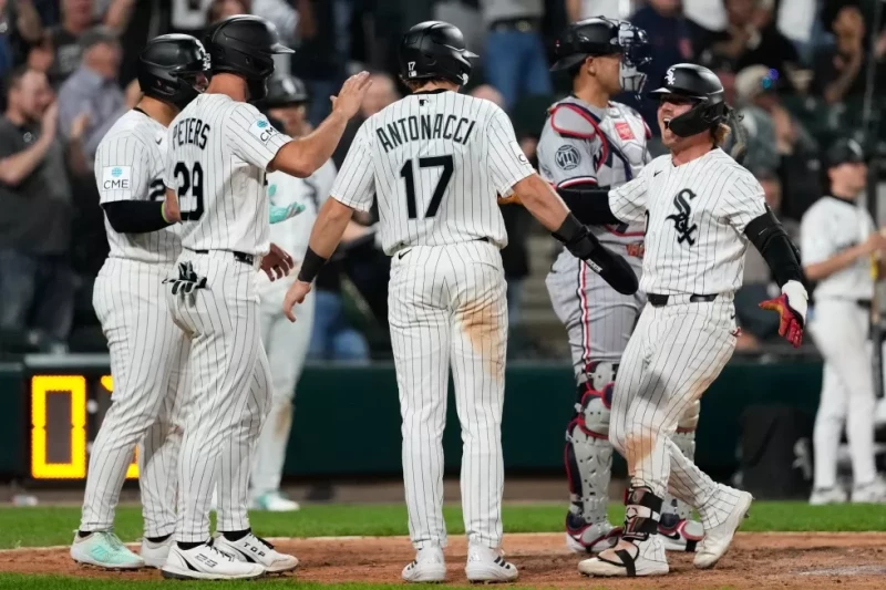 Chase Meidroth, de los Medias Blancas, celebra con Edgar Quero, Tristan Peters y Sam Antonacci después de batear un grand slam durante el juego de Grandes Ligas.