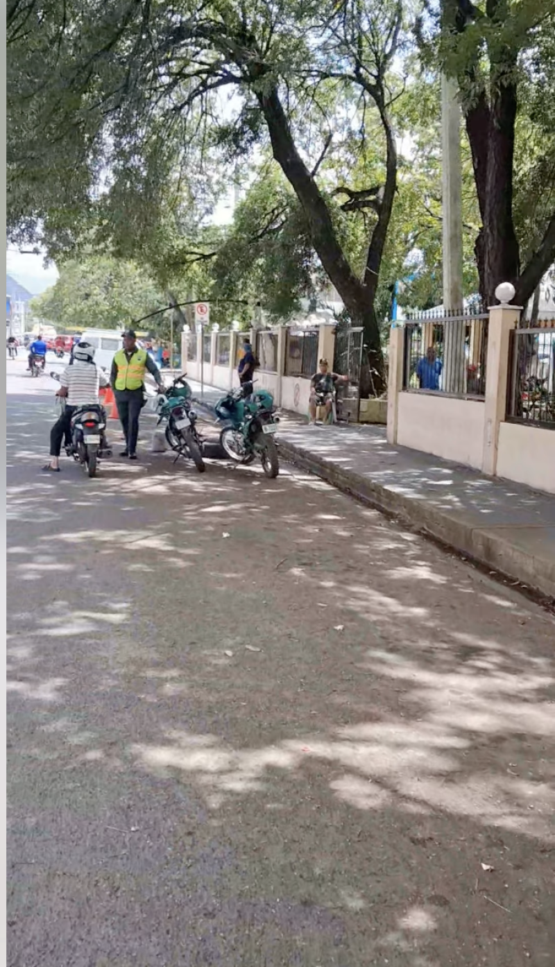 Un agente de la Digesset  vigila un lateral de la calle Canela Mota, en Baní, donde ejecutó un exitoso operativo para despejar la vía de la congestión de motoconchos que dificultaba el acceso público a clínicas y oficinas públicas.