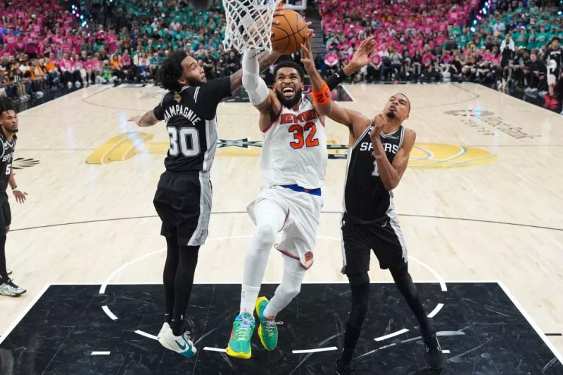 Karl-Anthony Towns, de los Knicks, encesta entre Victor Wembanyama y Julian Champagnie, de los Spurs, el 3 de junio de 2026.