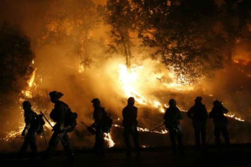 Varios bomberos y miembros del Departamento contra Incendios del Condado de Marin controlan un incendio en Valley, el 13 de septiembre de 2015 cerca de Middletown (California, EEUU) (Getty/AFP | Stephen Lam).