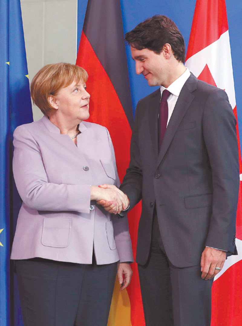 Líderes. Merkel y Trudeau.