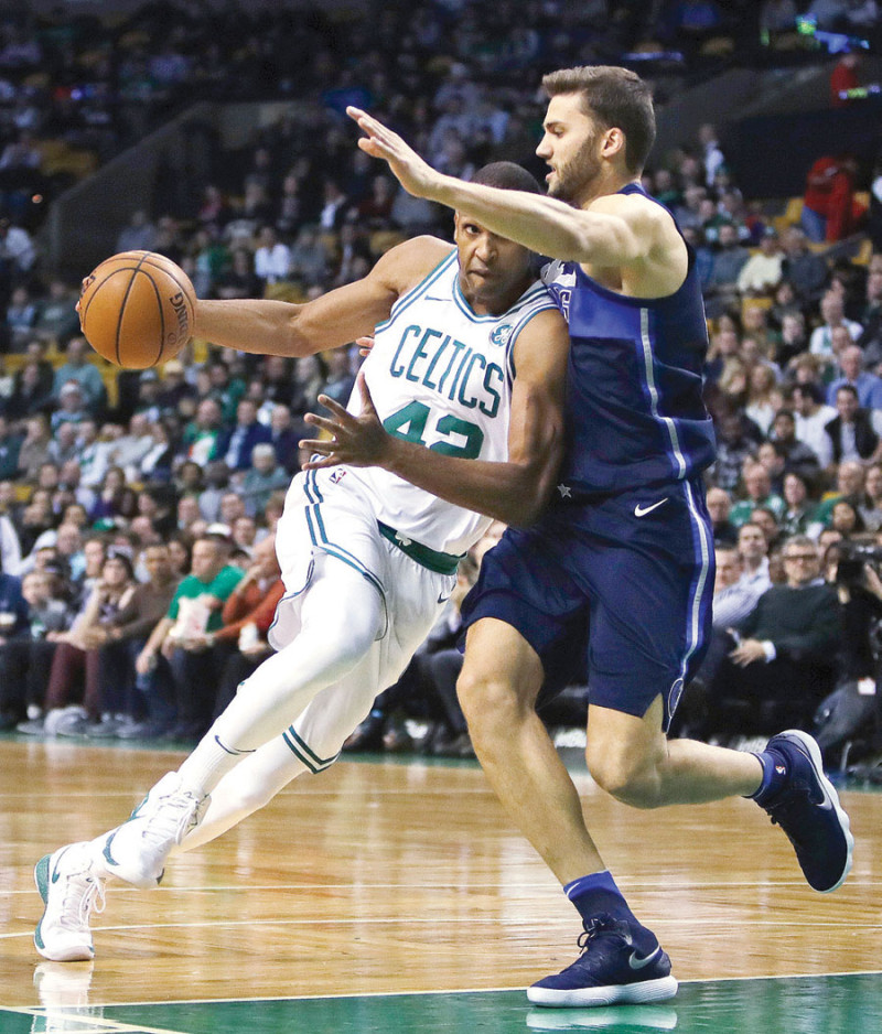 El dominicano Al Horford busca hacer ofensiva ante el asedio de Maxiimian Keber en el choque los Celtics vencieron a los Mavericks.