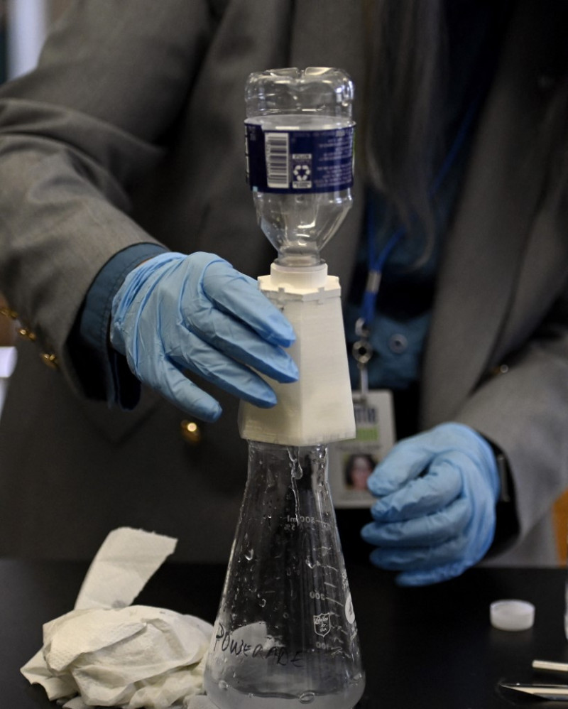 Rebecca Bushway demuestra el uso del purificador de agua desarrollado por los alumnos de su clase de Ciencias de la escuela secundaria Barrie Middle and Upper School, en Silver Spring, Maryland, el 21 de abril de 2022. Foto: Olivier Douliery/AFP.