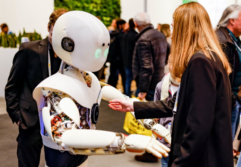 Una mujer interactúa con un robot