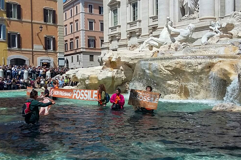 Una foto tomada y publicada como folleto el 21 de mayo de 2023 por activistas ambientales de Last Generation (Ultima Generazione) muestra al activista del grupo sosteniendo una pancarta que dice "no pagamos por el fósil" en la histórica Fontana di Trevi de Roma.