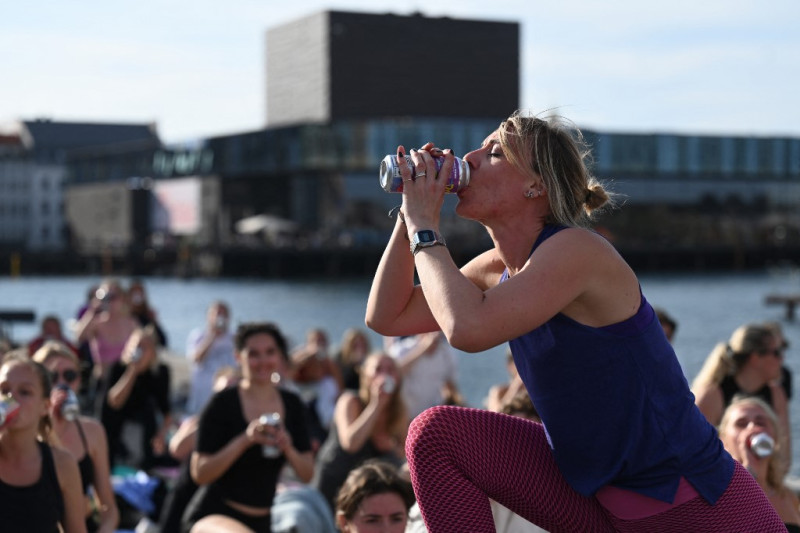 La instructora de yoga Anne Lund bebe cerveza durante el llamado "Beer Yoga event" en Copenhague, el 31 de mayo de 2023