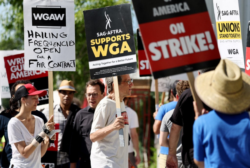 Un letrero dice 'SAG-AFTRA apoya a WGA' mientras los miembros de SAG-AFTRA caminan en la línea de piquete en solidaridad con los trabajadores en huelga de WGA (Writers Guild of America) frente a las oficinas de Netflix el 13 de julio de 2023 en Los Ángeles, California.