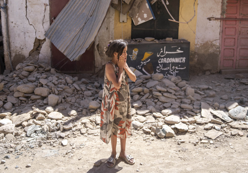 Una niña ve los daños causados por el reciente sismo en su localidad Amizmiz