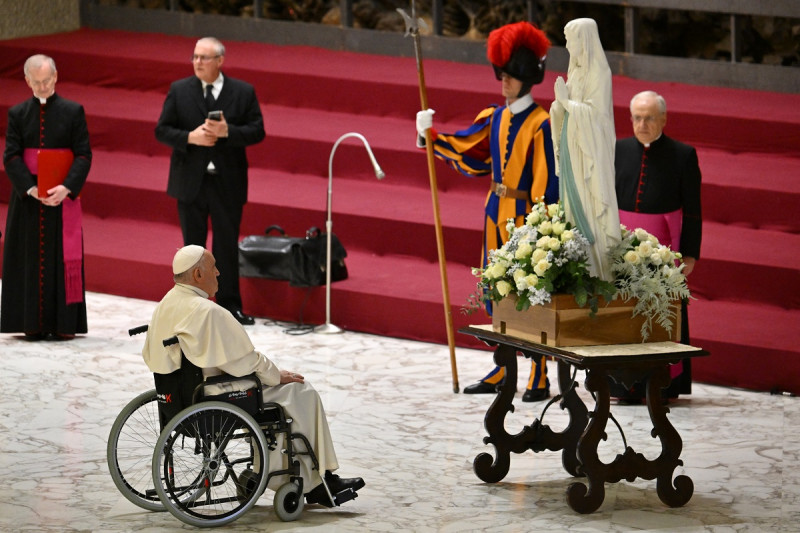 El Papa Francisco se encuentra frente a una estatua de la Virgen María durante una audiencia a los voluntarios y enfermos de UNITALSI en el salón Pablo VI del Vaticano el 14 de diciembre de 2023.