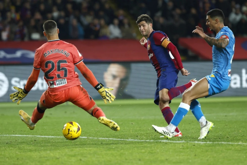 Sergi Roberto, centro, del Barcelona, anota el tercer gol de su equipo durante el partido de la Liga de España ante Almería en el estadio Olímpico Lluis Companys.