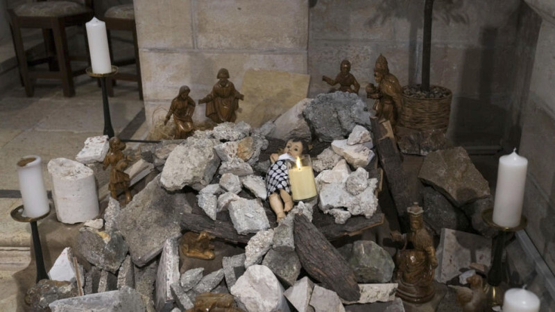 Instalación de una escena de la Natividad de Cristo con una figura que simboliza al niño Jesús tendido entre los escombros, en referencia a Gaza, en el interior de la Iglesia Evangélica Luterana de la Natividad de Belén.