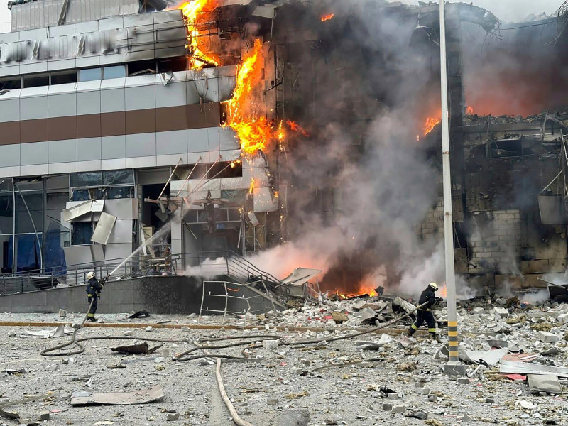 Bomberos ucranianos trabajan para sofocar un incendio en un edificio dañado por un ataque ruso, en Kiev, ayer.