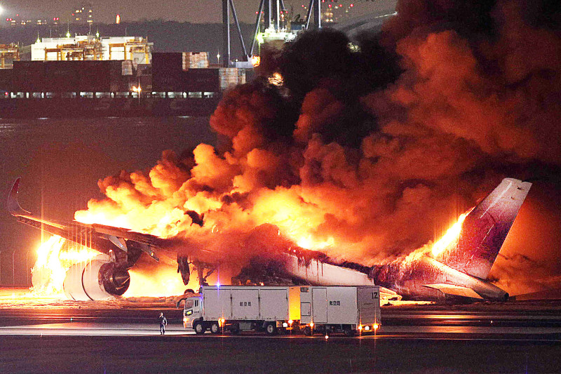 This photo provided by Jiji Press shows a Japan Airlines plane on fire on a runway of Tokyo's Haneda Airport on January 2, 2024. A Japan Airlines plane was in flames on the runway of Tokyo's Haneda Airport on January 2 after apparently colliding with a coast guard aircraft, media reports said. (Photo by JIJI PRESS / AFP) / Japan OUT