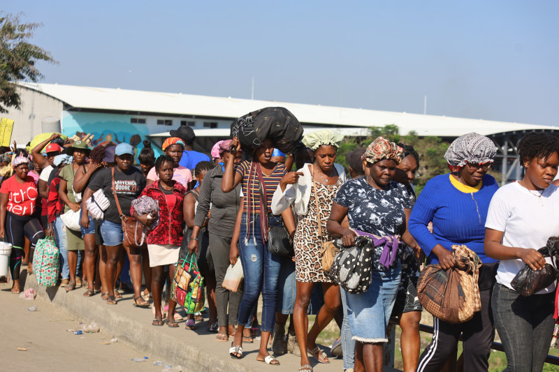 Haitians cross the border between Quanamienthe in Haiti and Dajabon in the Dominican Republic to work in the binational market in Dajabon, Dominican Republic on March 8, 2024. (Photo by Erickson POLANCO / AFP)