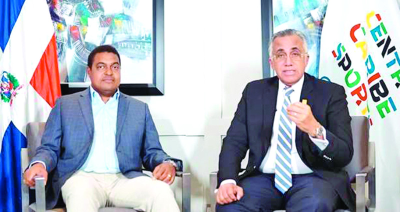 José P. Monegro y Luis Mejía, presidentes del Comité Organizador Santo Domingo 2026 y Centro Caribe Sports, respectivamente.