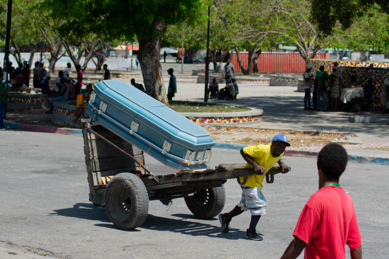 A man pulls a cart with a casket through a street in Port-au-Prince, Haiti, March 22,2024. More than 33,000 people fled Port-au-Prince this month as the Haitian capital was overrun by well-armed gangs triggering political chaos in the impoverished Caribbean nation, the United Nations has said. (Photo by Clarens SIFFROY / AFP)