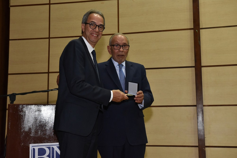 Dennis Simó entrega un reconocimiento a José Mármol, del Banco Popular.