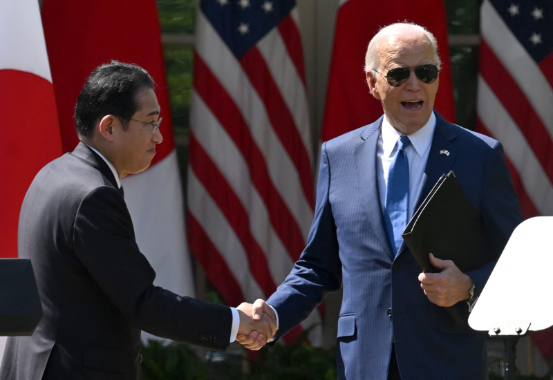 US President Joe Biden and Japanese Prime Minister Fumio Kishida shake hands after a joint press conference in the Rose Garden of the White House in Washington, DC, April 10, 2024. (Photo by ANDREW CABALLERO-REYNOLDS / AFP)