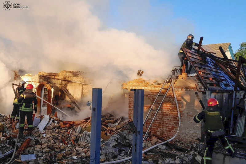 Rescatistas ucranianos  trabajan en un edificio dañado después de un ataque de misiles rusos en la región de Kiev.
