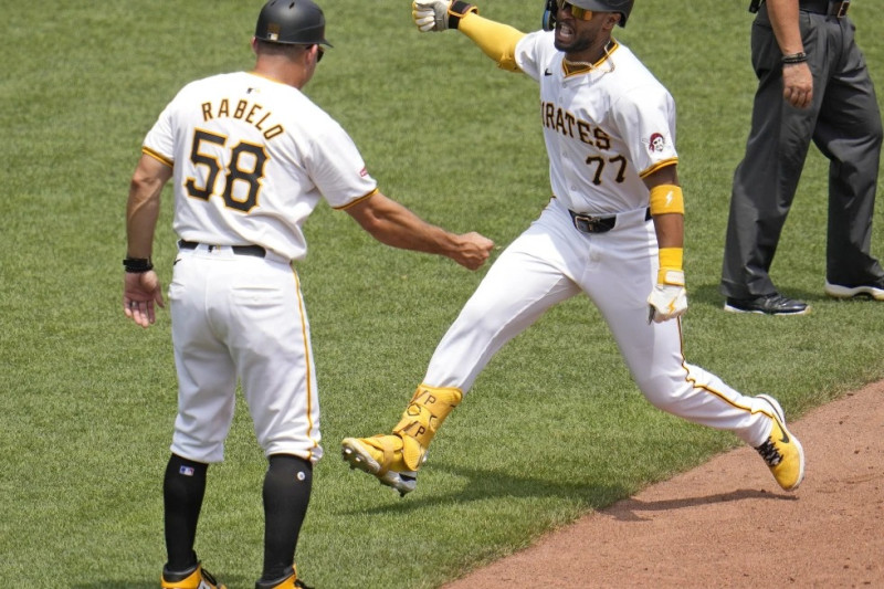 Joshua Palacios (77), de los Piratas, da vuelta por tercera frente al coach Mike Rabelo (58) tras conectar un jonrón solitario ante el relevista de los Mets Adrian Houser.