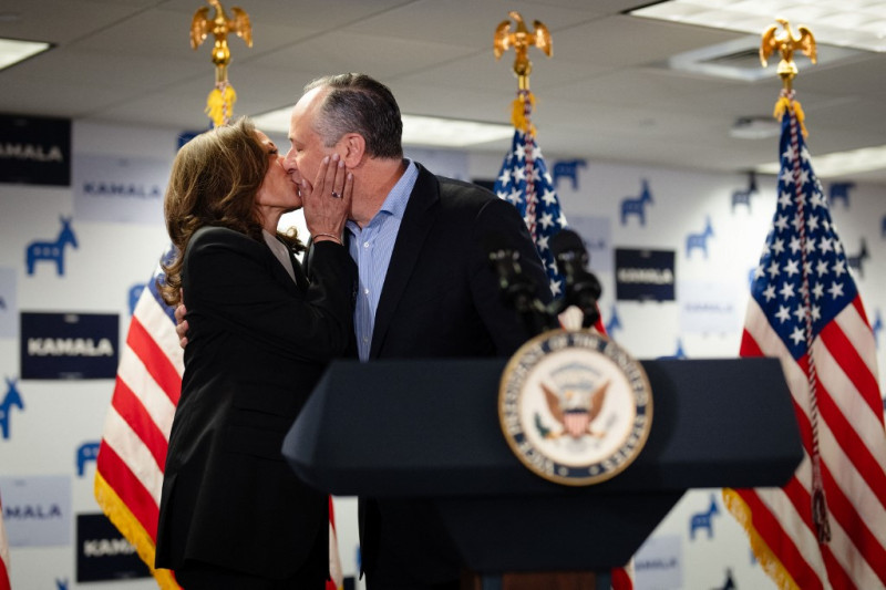 La vicepresidenta Kamala Harris y su esposo, el segundo caballero Douglas Emhoff, se besan ayer en el escenario en la sede de la campaña presidencial de la primera en Wilmington, Delaware.