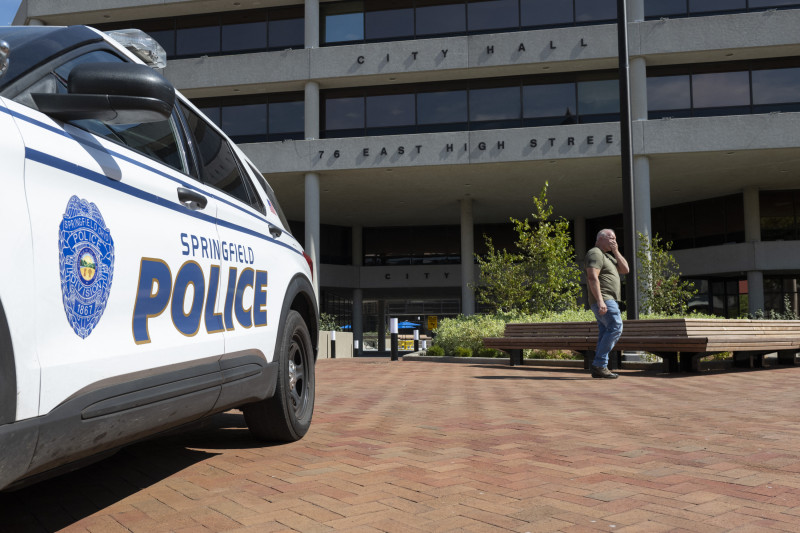 A man walks past the Springfield City Hall after bomb threats were made against buildings earlier in the day in Springfield, Ohio on September 12, 2024. - A government building and school were evacuated after an alleged bomb threat Thursday in Springfield, Ohio, local media reported, rattling the small city at the heart of an anti-migrant conspiracy theory amplified by Donald Trump. Springfield has been thrust into the spotlight in recent days after an unfounded story of Haitian migrants eating pets went viral on social media, with the Republican ex-president and current White House candidate pushing the narrative despite it being debunked. (Photo by ROBERTO SCHMIDT / AFP)