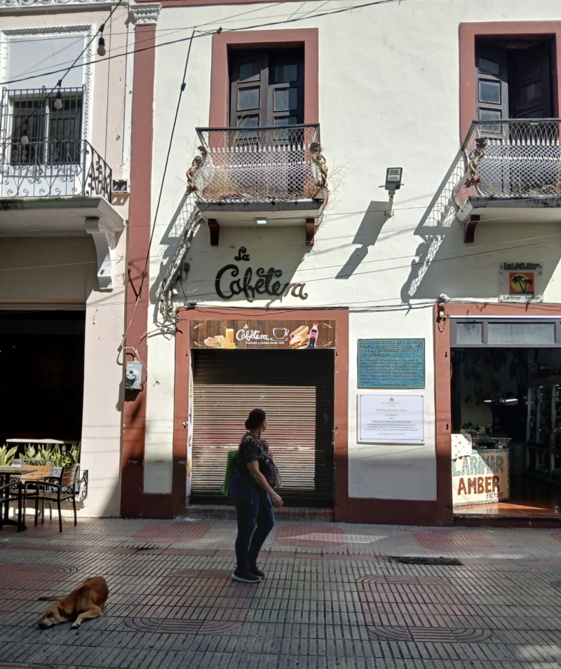 Una mujer observa el local recién cerrado de La Cafetera, el icónico negocio ubicado en la calle El Conde de la Ciudad Colonial.