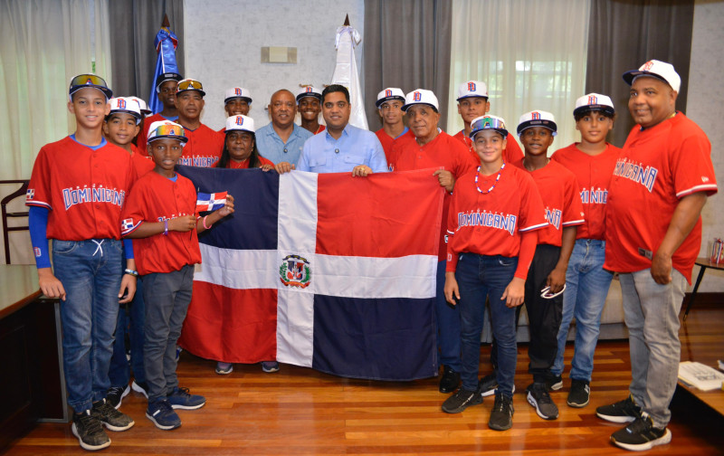 El ministro Kelvin Cruz al momento de hacer entrega de la bandera nacional a  Juan Núñez Nepomuceno y al equipo dominicano.,