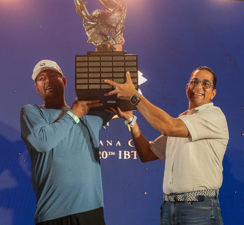 Jorge Subero Medina (derecha), premia a Hunter Baron como el mejor pescador del clásico de pesca al marlin azul.