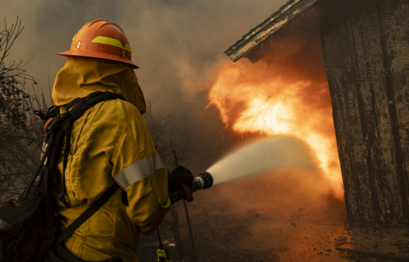 A firefighter attempts to control the blaze burning a structure as the Santa Ana wind-fed Mountain fire scorches acres, in Camarillo, California, on November 6, 2024. - A wildfire fanned by powerful winds was burning out of control near Los Angeles on November 6, with scores of residents ordered to evacuate and some taken to hospital.
Fierce gusts up to 80 miles (130 kilometers) an hour were pushing smoke sideways and fueling flames that were tearing through farmland. (Photo by ETIENNE LAURENT / AFP)