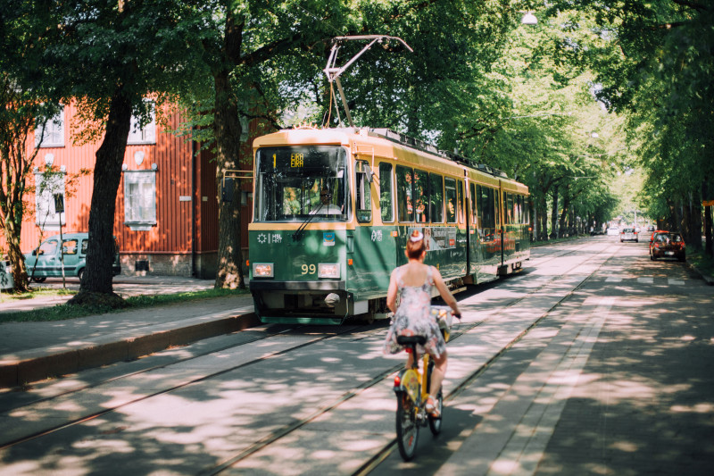 Chica en bicicleta y tranvía en calle Pohjolankatu. Foto de Visit Finland.