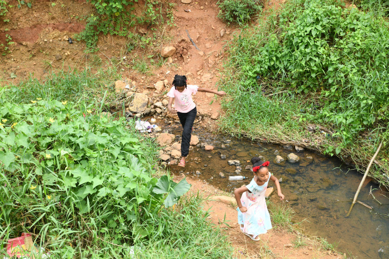 Los niños tienen que pasar el río Higüero dando saltos sobre piedras y sacos de arena. Cuando hay crecida, no pueden ir a la escuela por la falta de un puente.