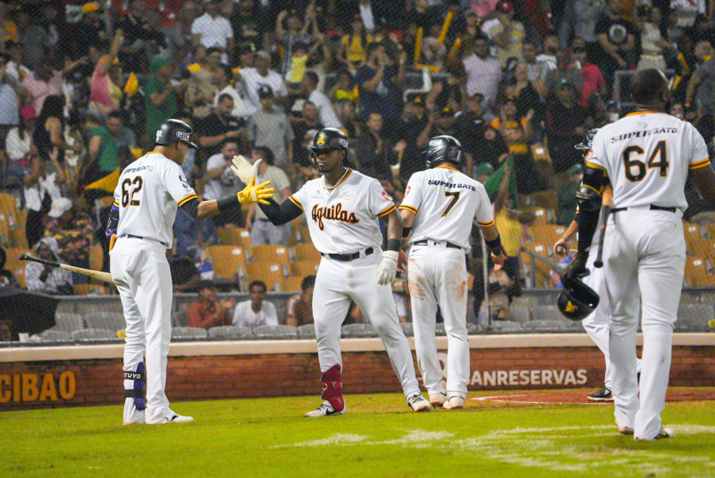 Jugadores de las Águilas celebran luego de conectar jonrón.