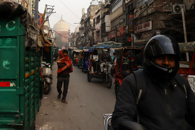 Unos hombres conducen un rickshaw por el casco antiguo en un brumoso día de invierno.Inde, Vieille Delhi, 2023/01/03.