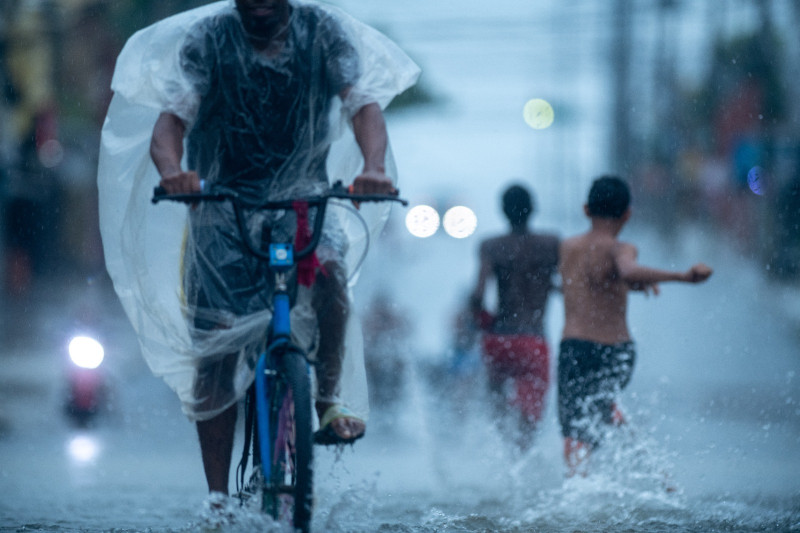 Niños juegan en la lluvia.