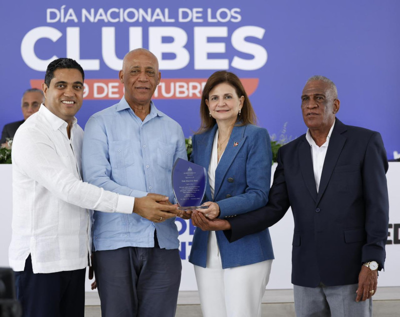 La vicepresidenta Raquel Peña y el ministro Kelvin Cruz entregan una placa de reconocimiento a José (Boyón) Domínguez, presidente del Club Mauricio Báez. .