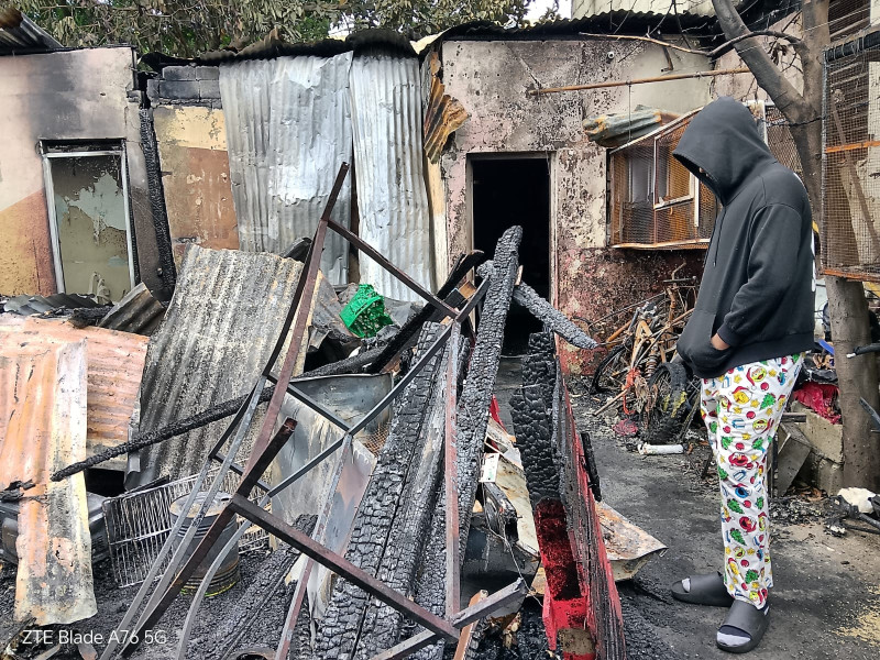 Una persona observa los escombros dejados por el incendio que consumió las viviendas.
