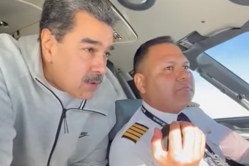 En esta imagen tomada de un video publicado en la cuenta de Facebook del presidente venezolano, Nicolás Maduro, el 15 de diciembre de 2023, Maduro se ve junto al piloto Bitner Villegas en la cabina de un avión