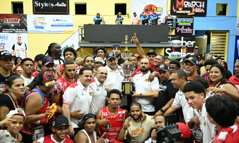 Ariel Vásquez, presidente de ASOBAE, entrega al presidente del San Sebastián José Ramon Peña la corona de campeones del BSE de Moca.