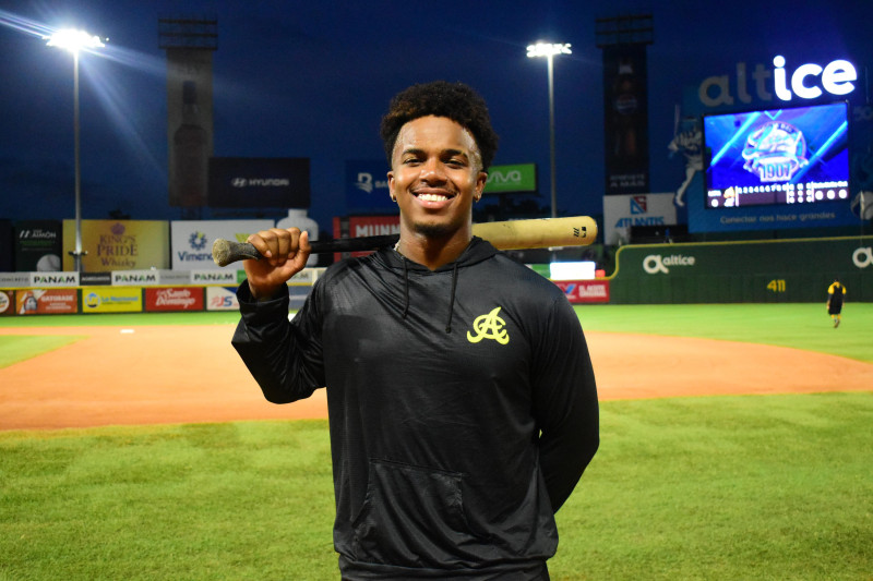 Adael Amador, campocorto de las Águilas Cibaeñas, sostiene su bate tras terminar prácticas.