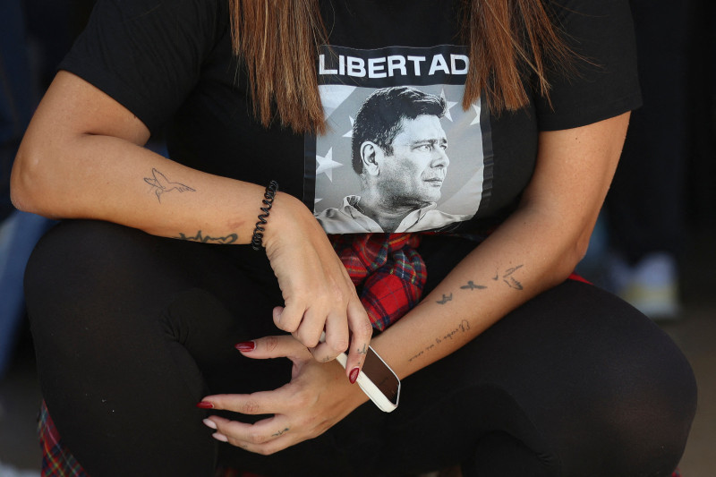 Una mujer con una camiseta que dice "Libertad" asiste a un evento solidario en apoyo a las familias de presos políticos en la Universidad Central de Venezuela.