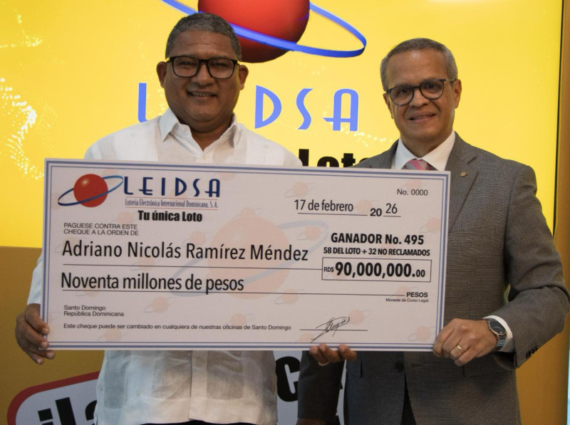 Adriano Nicolás Ramírez Méndez recibe el cheque 90 millones de pesos de manos de Manuel Abreu.