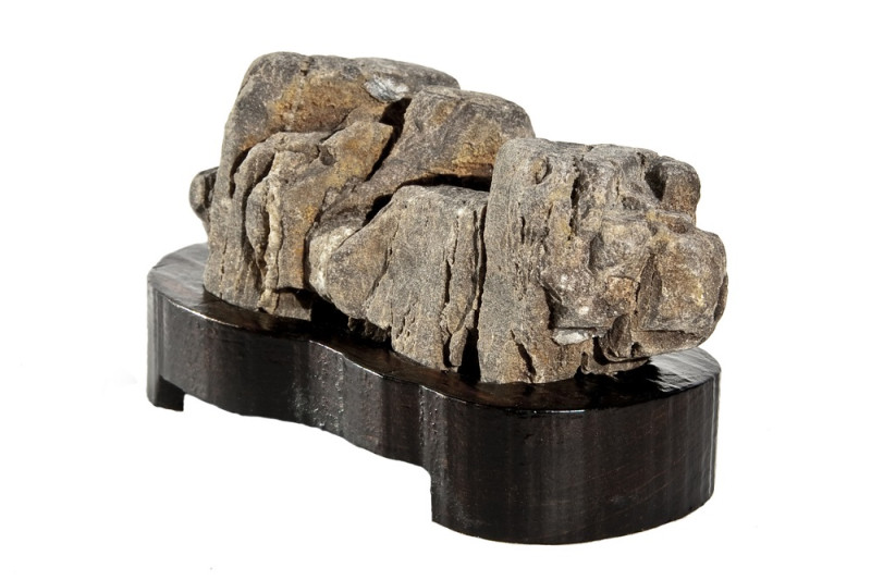 Imagen de suiseki con su característica base de madera.