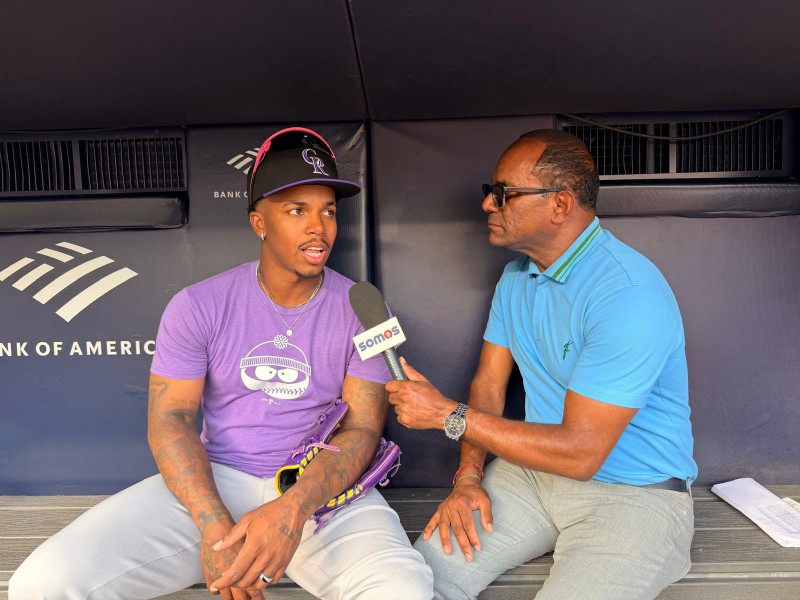El periodista Daniel Reyes sostiene una conversación con el infielder Adael Amador.