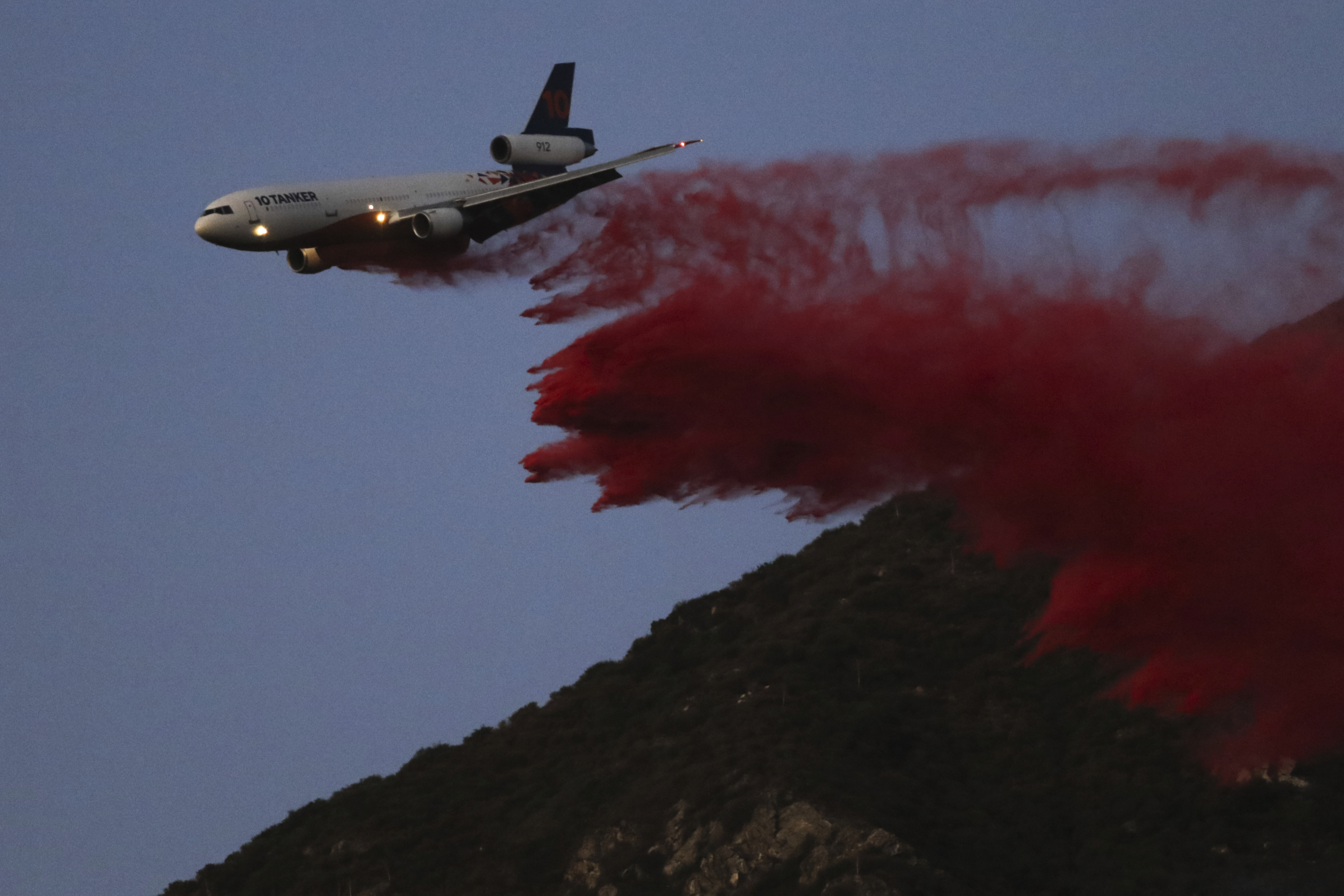 Air tanker drops retardant while fighting Eaton fire