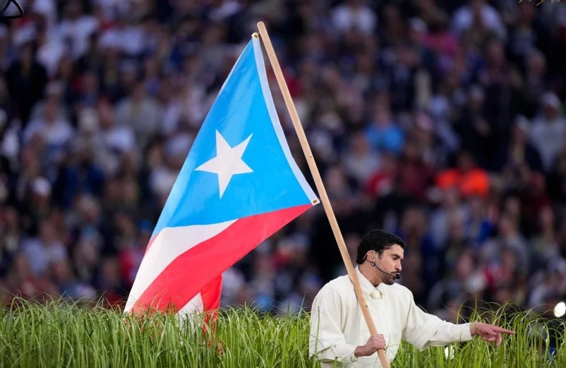 Bad Bunny sostuvo una bandera de Puerto Rico en rojo, blanco y azul celeste, reflejo del movimiento independentista puertorriqueño.